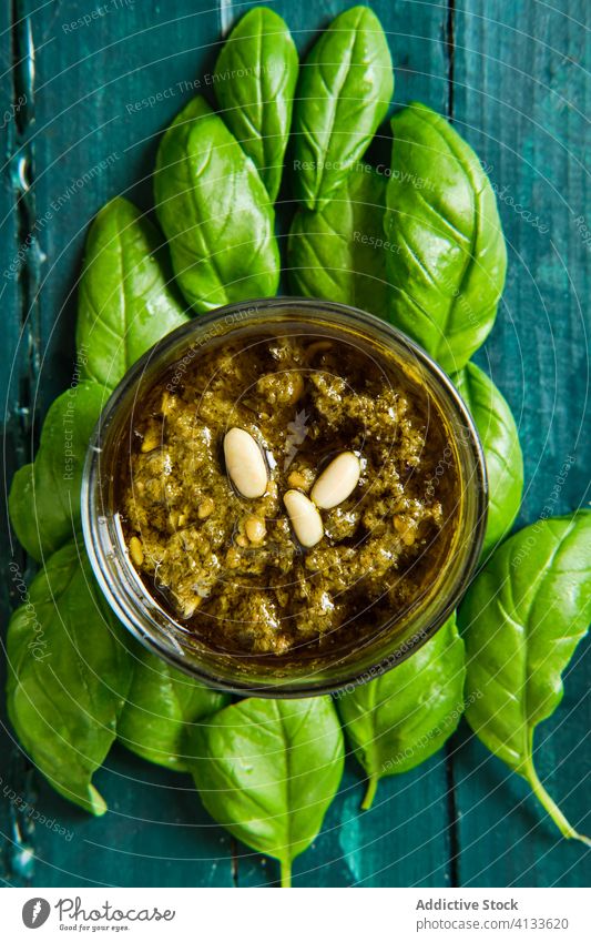Bowl with pesto salsa on aromatic basil leaves sauce leaf fresh ingredient herb organic gourmet italian olive oil culinary cuisine delicious crispy pine nut