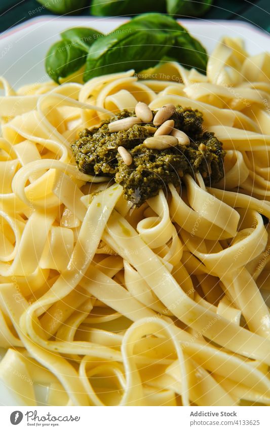 Tasty pasta with pesto salsa and fresh basil in restaurant sauce pine nut lunch tasty food dish tagliatelle dinner delicious meal cuisine gourmet italian