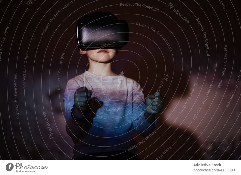 Bright projection on excited boy in VR headset vr colorful experience kid virtual reality explore technology simulation device gadget amazed face expression