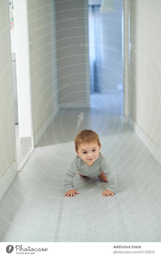 Happy baby crawling on floor happy cute smile home toddler child childhood cheerful kid joy lifestyle sweet development explore experience glad play excited