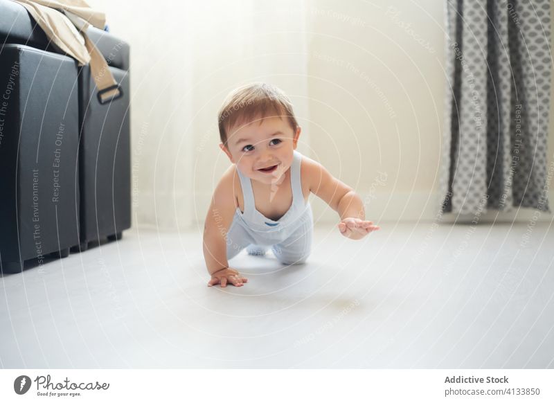 Happy baby crawling on floor happy cute smile home toddler child childhood cheerful kid joy lifestyle sweet development explore experience glad play excited
