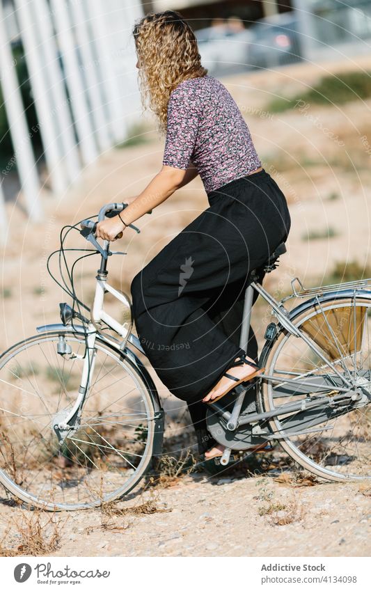 Tranquil woman with bicycle in park bike summer weekend enjoy walk cyclist calm female sunny tranquil serene outfit daytime rest relax green recreation lady