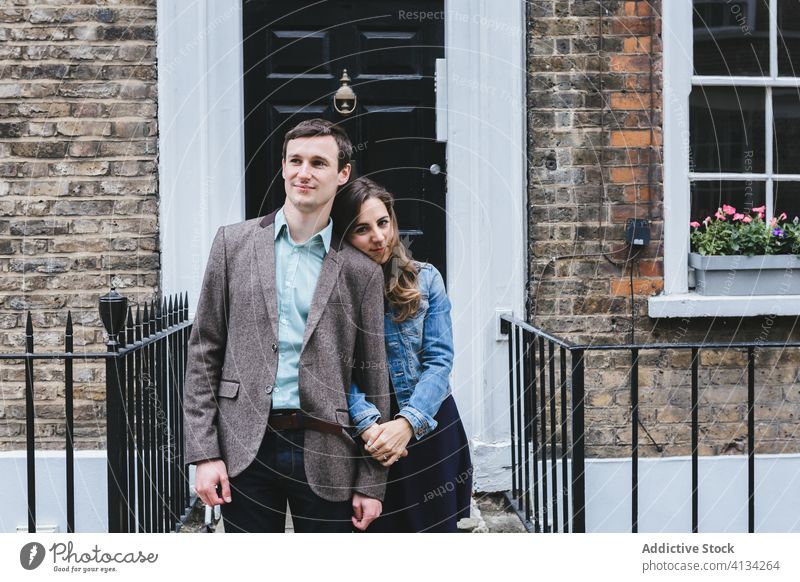 Couple near building on street shabby couple city together love relationship romantic exterior london england united kingdom casual urban affection stand door