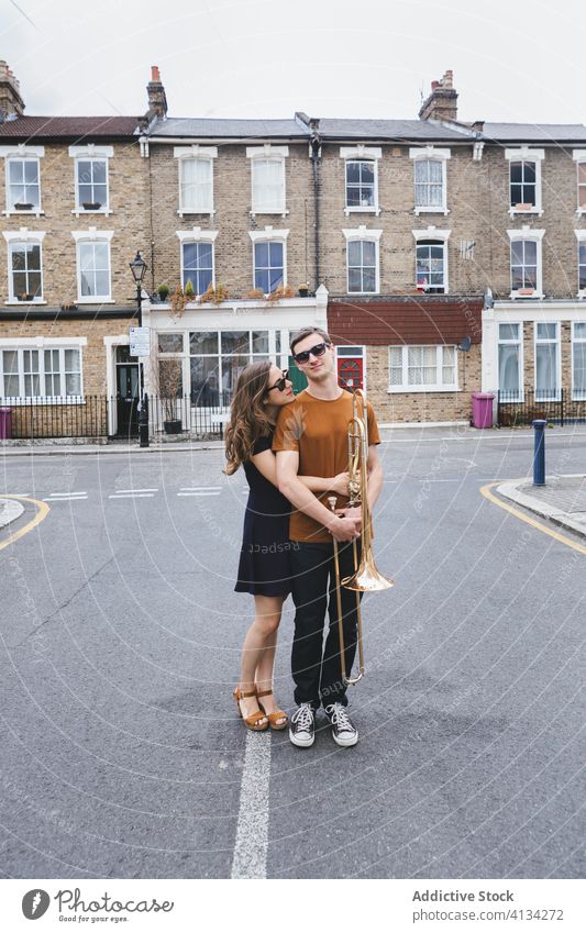 Hipster couple with trombone on city street style cool music instrument together embraced relationship musician london hipster vintage england united kingdom