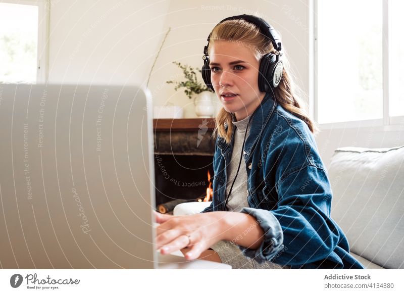 Young woman playing synthesizer at home piano learn online music electronic musician laptop tutorial young composer female modern device gadget hobby lifestyle