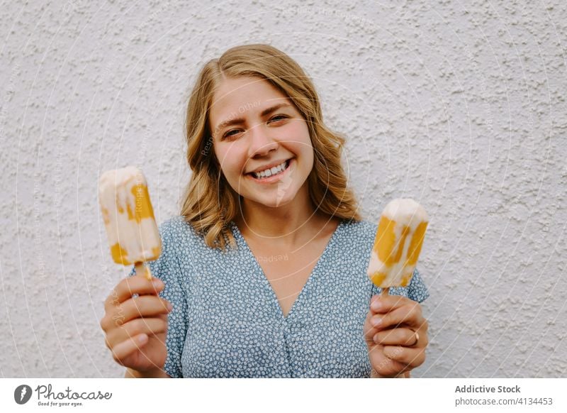 Happy woman with popsicles on white background ice cream having fun lolly tasty smile female cheerful happy joy delicious stick funny looking at camera playful