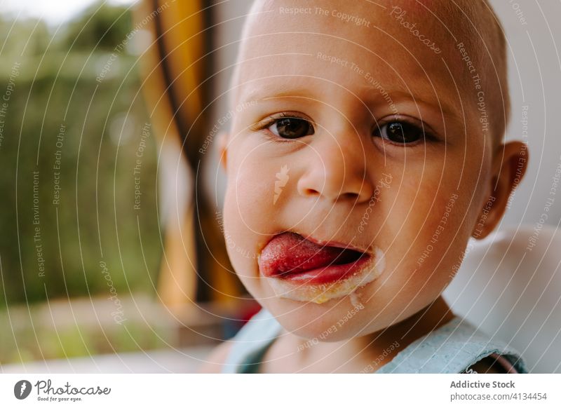 Adorable toddler eating delicious ice cream popsicle dirty mouth child enjoy tasty homemade summer adorable treat terrace rest kid little childhood relax