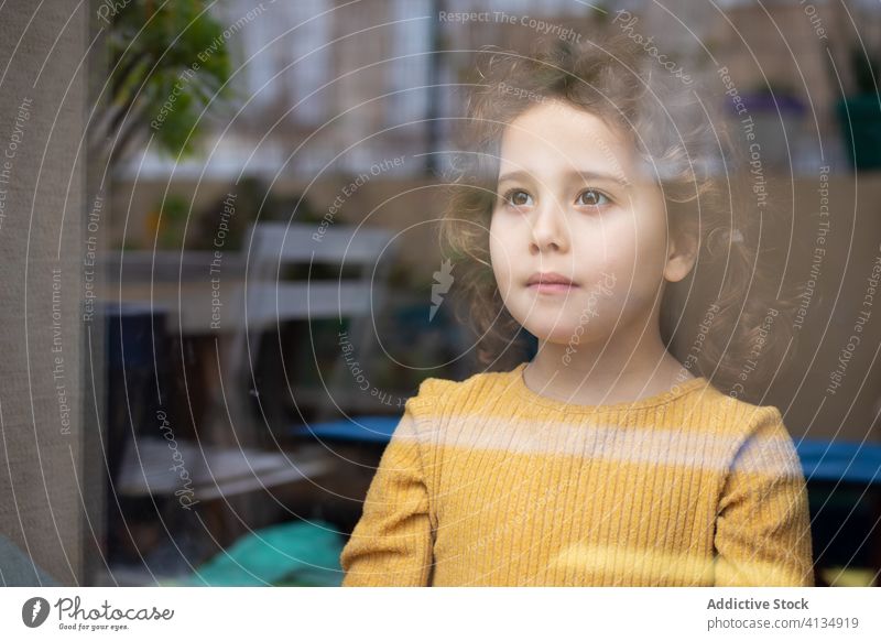 Pensive child looking out window kid home pensive thoughtful dream girl imagination think alone miss lonely quarantine ponder calm little contemplate tranquil