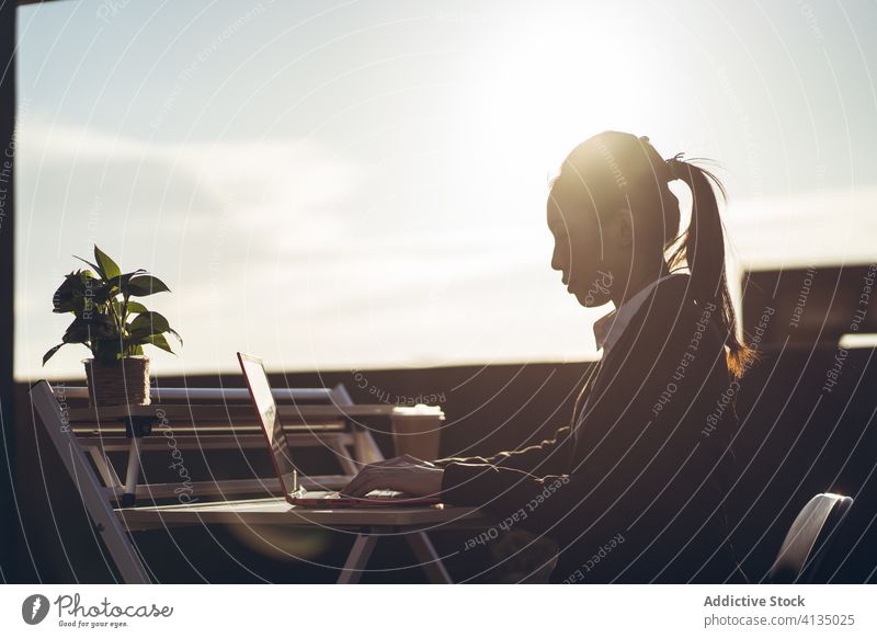 Busy woman with laptop working on rooftop using businesswoman formal device gadget asian young female internet communicate browsing connection entrepreneur