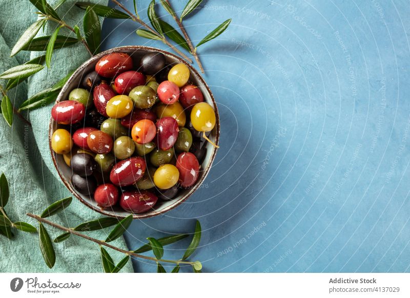 Olives. A variety of green, black and red olives, with leaves, shot from the top with a place for text kalamata brown assortment overhead above antipasti view