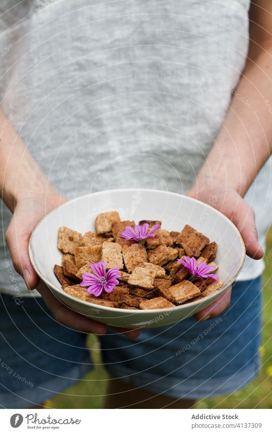 Crop woman with bowl of cereal breakfast cinnamon countryside morning yummy crunch crispy female ceramic food tasty delicious dessert healthy sweet ingredient