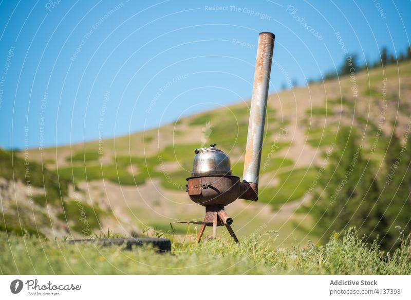 Old wood stove on hill in sunny weather old rust landscape grass kettle metal picturesque grassy terrain nature rural countryside environment natural steel