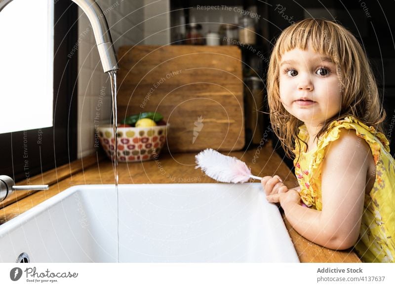 Girl ready to wash hands child water soap kitchen home sink tap counter kid cozy lifestyle piece wet domestic routine childhood fresh harmony little innocent