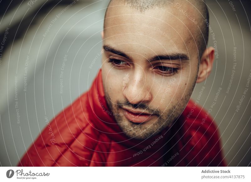 Young hipster man in red jacket young modern pensive unshaven beard thoughtful portrait think bald male smile handsome guy casual style urban trendy positive