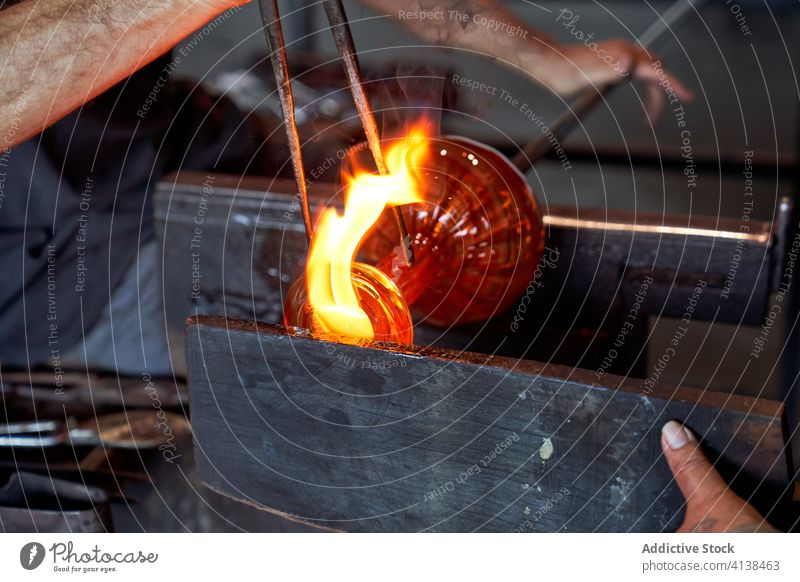 Faceless artisans glass blowing shisha base craftsmanship molten manufacture professional occupation handicraft flame hot process tweezers blowpipe teamwork men