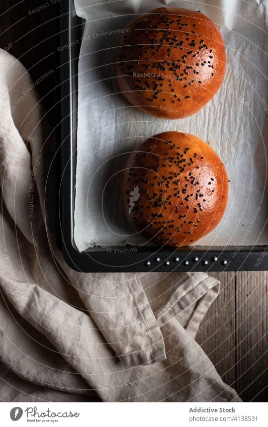 Burger buns with sesame seeds in kitchen burger roll baked table delicious food tradition nutrition fresh bread culinary gourmet tasty meal paper cuisine serve