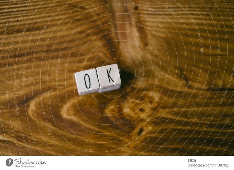 The word OK written with letter cubes on wood okay apprehended nagut Letters (alphabet) Word authored Text writing Approval Yes Communicate all right Wood