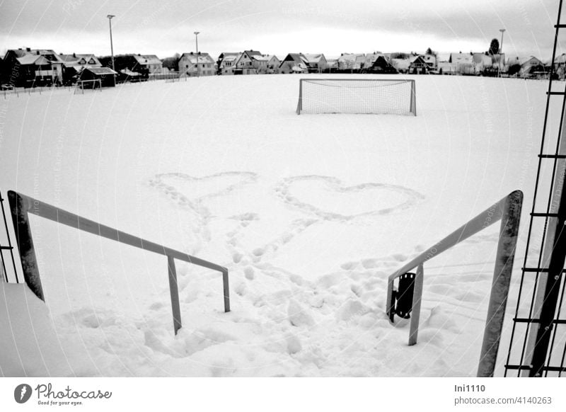 Two hearts in the snow Snow cuddle Heart Football pitch Goal rail Winter Love In love Infatuation Sign show affection Emotions symbolize sb./sth. Soccer Goal