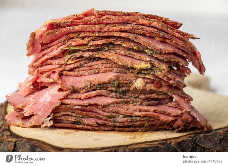 Slices of sliced pastrami meat Beef brisket Rustic meat slices Cut Stack Meat Close-up Red deli cut Cold Folded Thin roasted Eating seethed Delicacies Frying