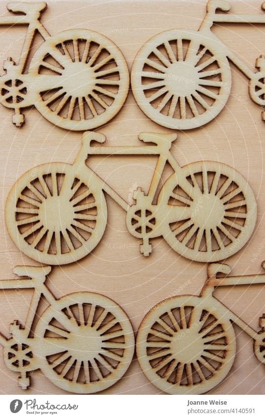 Wooden cutout bicycles on a wood background. Bicycle Wheels Transport Cycling bike biking Cycling tour transportation ride Pedal lifestyle cyclist travel