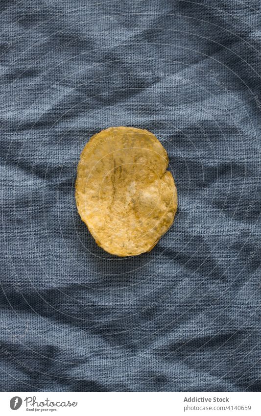 Potato chip on napkin on table potato crispy snack fast food tasty junk food delicious salty appetizer meal appetizing gastronomy culinary dry yummy gourmet