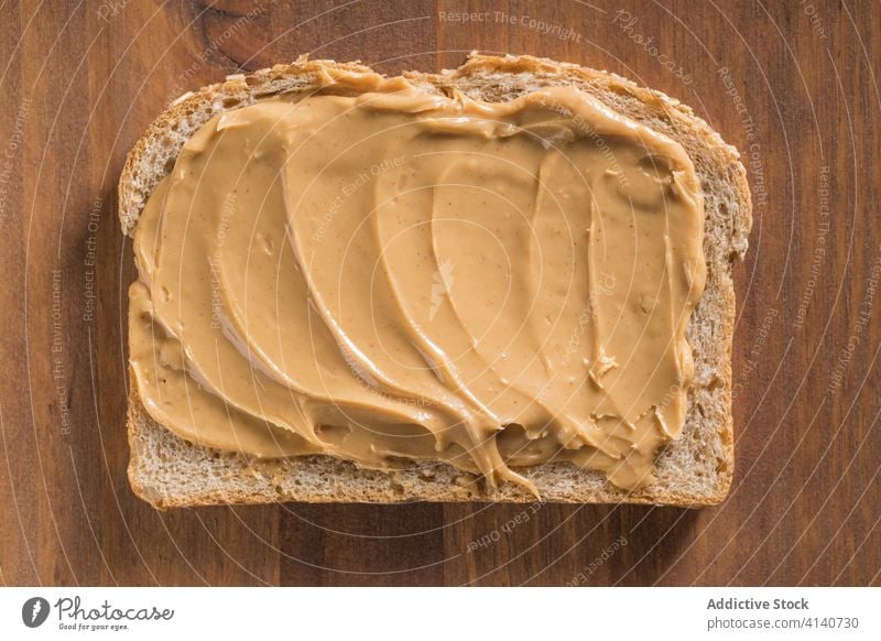 Delicious toast with peanut butter on cutting board bread delicious breakfast food piece tasty nutrition table wooden kitchen chopping board meal healthy