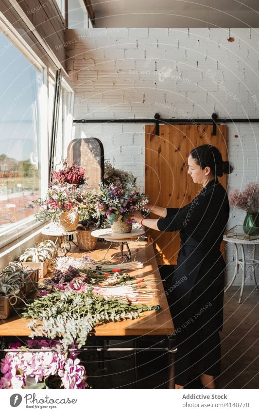 Female designer creating floral bouquets in studio floristry woman arrange create bloom blossom compose decorative female creative work occupation professional