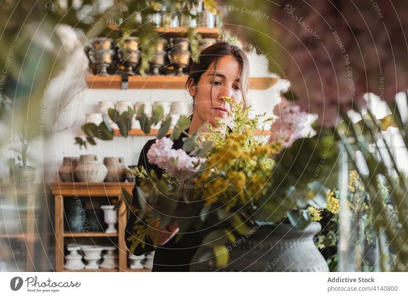 Female designer creating floral bouquets in studio floristry woman arrange create bloom blossom compose decorative female creative work occupation professional