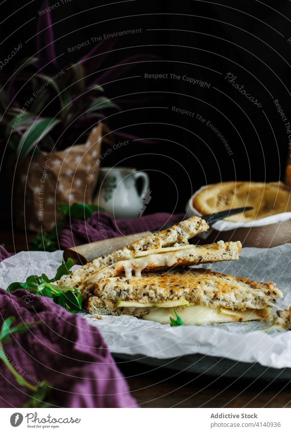 Sandwich and baked Camembert cheese on kitchen table omelet camembert sandwich white mould cheese bread toast delicious serve plate ingredient healthy fruit