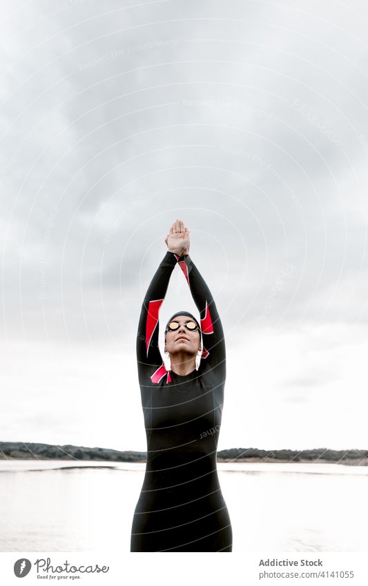 Woman in wetsuit wearing glasses on lake of shore woman diver goggles swimsuit extreme environment swimmer aqua sporty travel determine prepare sportswoman
