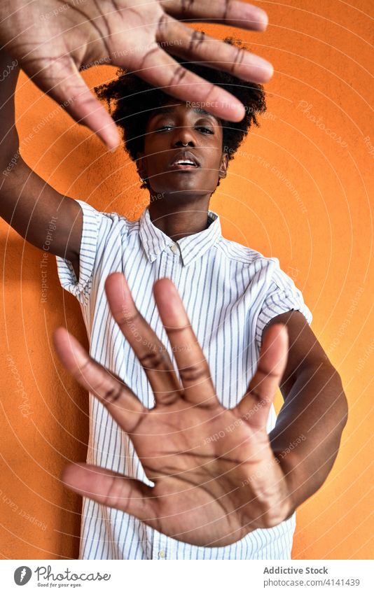 Serious black woman with hands raised protesting and trying to stop violence prevent against gesture sign dissuade objection concept renouncement refuse serious
