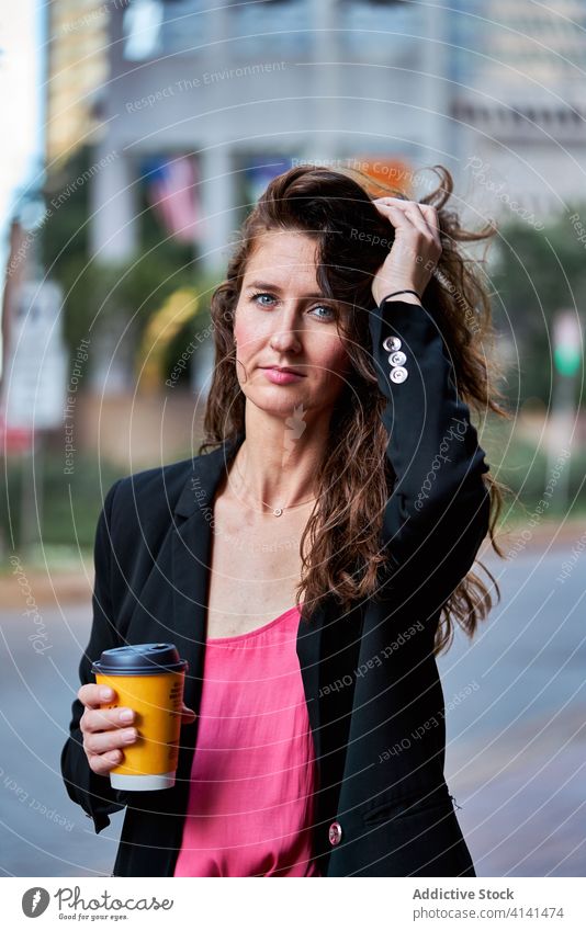 Confident woman with takeaway coffee on street to go businesswoman break city refreshment entrepreneur confident female elegant jacket paper cup drink beverage