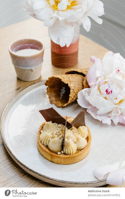 Delicious caramel tart with chocolate dessert sweet garnish waffle cone flower treat white chocolate palatable delicious food tasty pastry fresh yummy tray