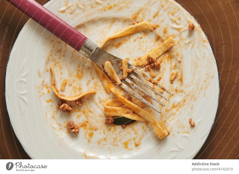 Dirty plate after eating pasta with sauce bolognese food fork empty cuisine culinary dirty smear delicious meal recipe kitchen natural portion hungry homemade