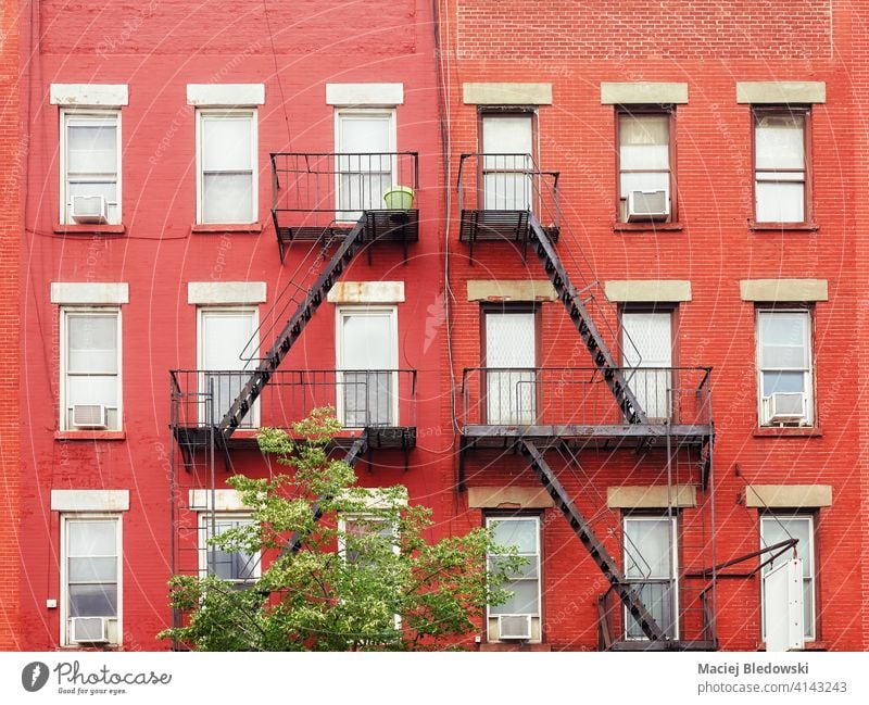 Old red brick buildings with iron fire escapes, New York City, USA. wall city old townhouse home apartment architecture stairs facade NYC ladder view