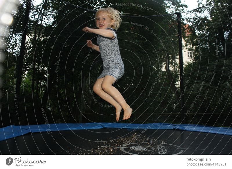 happy jumping girl on a trampoline Child cheerful Movement Hop Trampoline Jump Playing Girl Joie de vivre (Vitality) Infancy fun Joy Happiness salubriously fit