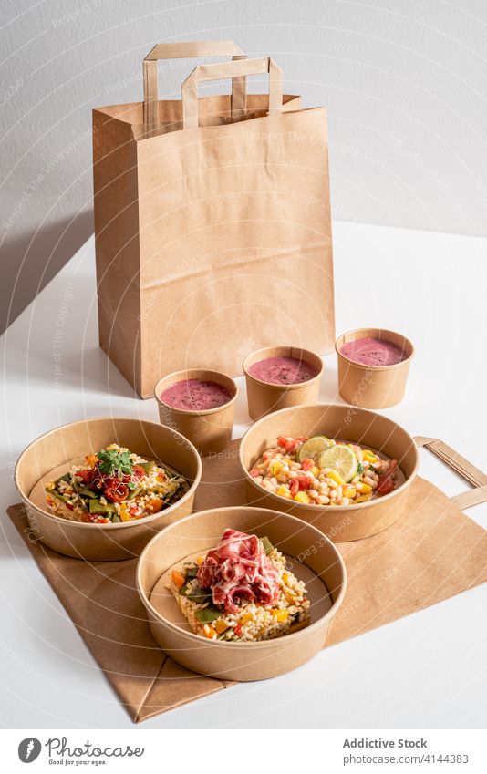 Various healthy food in takeaway bowls on table various delicious eco friendly package container shrimp ceviche beetroot cream rice paper carton prawn ceviche