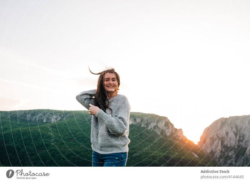 Smiling woman in mountains during sunset traveler highland carefree holiday enjoy relax summer female transylvania romania saint george happy tourism adventure