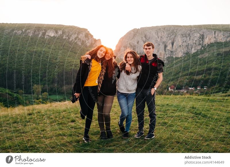 Company of friends together in highlands mountain spectacular friendship hug vacation group sunset transylvania romania saint george happy smile embrace joy