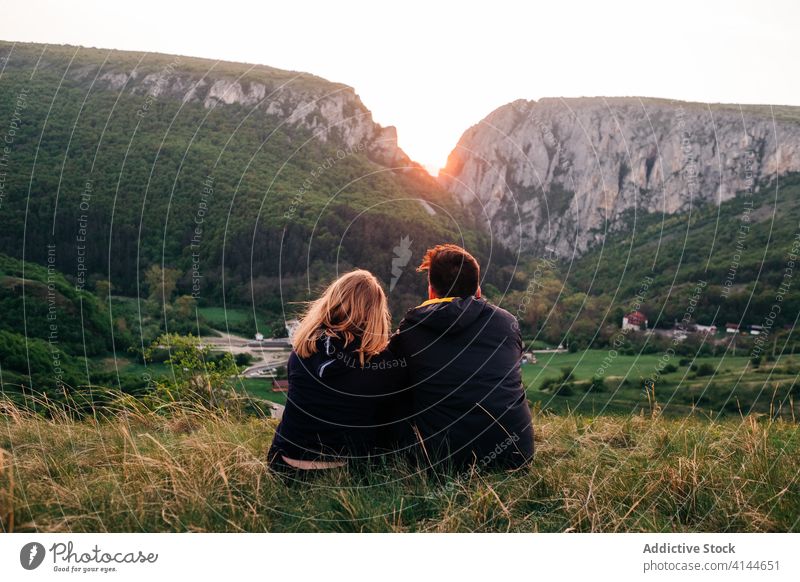 Anonymous traveling couple hugging in highlands vacation enjoy sunset together mountain range holiday transylvania romania saint george tourism embrace love