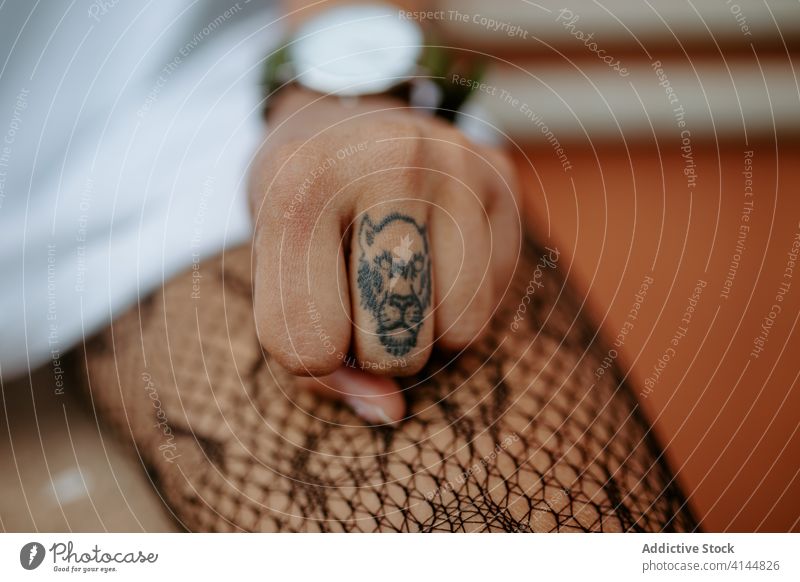Crop woman with tattoo on finger millennial animal shape brutal extraordinary independent generation city female urban street sit style show demonstrate modern