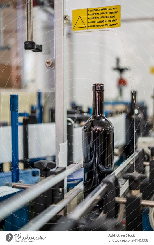 Bottle of wine on conveyor belt in factory bottle equipment manufacture viticulture modern production process professional technology machine quality beverage