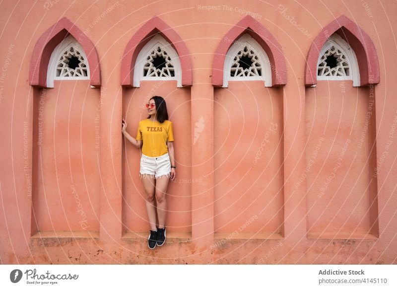 Smiling ethnic woman in arch of UMS Mosque pink mosque travel sightseeing summer tourist holiday ums mosque smile female asian kota kinabalu sabah borneo