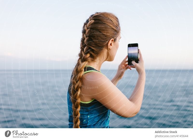 Woman taking photo of sea take photo smartphone woman amazing seascape using memory vacation female travel mobile device holiday gadget water summer photography