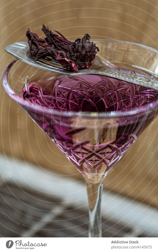 Spoon with dried petals on cocktail glass spoon flower decor serve bar violet goblet elegant natural drink beverage alcohol fresh fragile aroma fragrant party