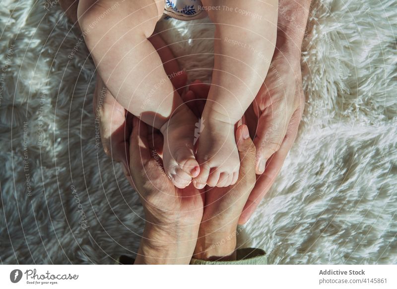 Mother hands holding feet baby family child soon boy dad father mom mother fun enjoy home at home stay at home beautiful model portrait flat people happy family