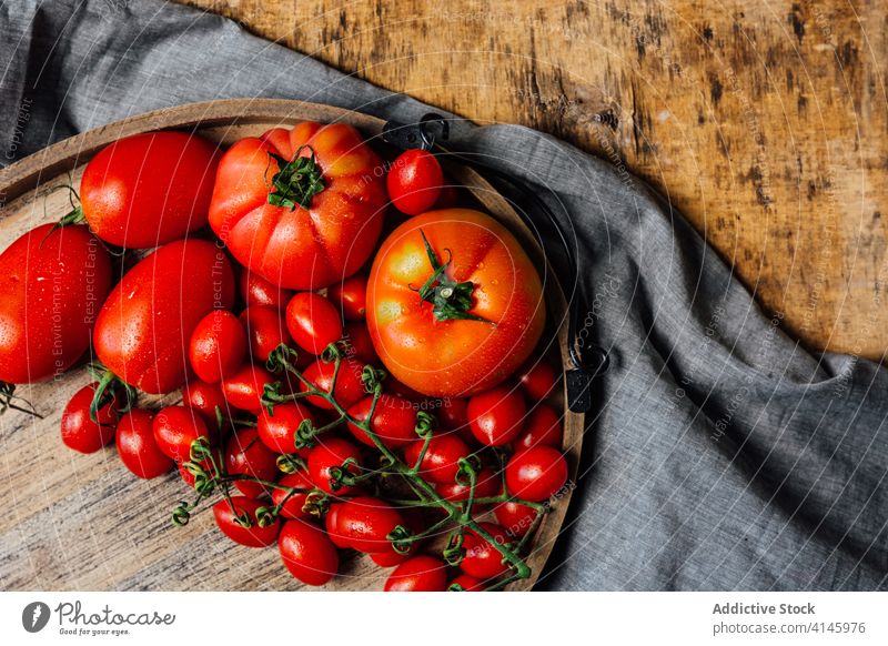 Fresh red tomatoes on table fresh ripe assorted various mix natural food vegetable rustic cherry organic healthy nutrition vitamin ingredient raw vegetarian