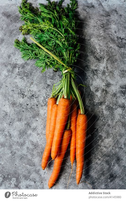 Bunch of fresh carrots on table bunch natural organic vitamin vegetable healthy ripe raw ingredient food nutrition diet vegetarian vegan uncooked cuisine meal