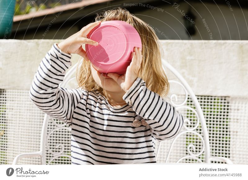 Cute child eating soup from bowl tasty summer terrace kid adorable sunny chair backyard little relax sit rest childhood fresh meal cute food healthy comfort