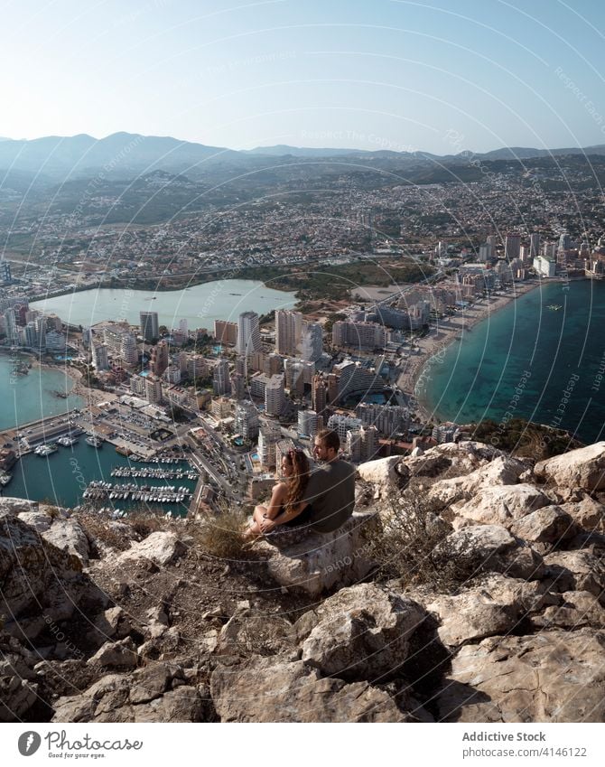 Traveling couple enjoying wonderful scenery of Alicante from high hill cityscape alicante embracing viewpoint picturesque rocky mountain romantic spain scenic